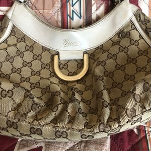 Gucci—coated cotton with leather strap—well worn